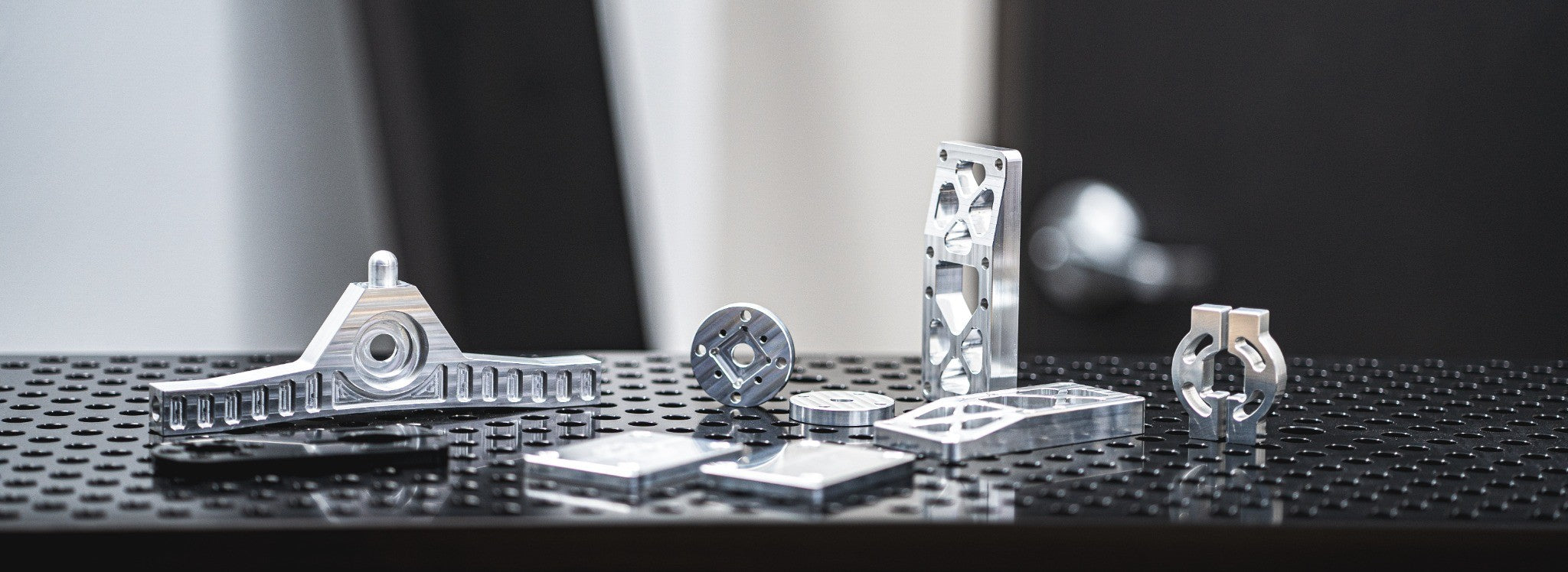 Selection of finished machined metal parts on a fixture table